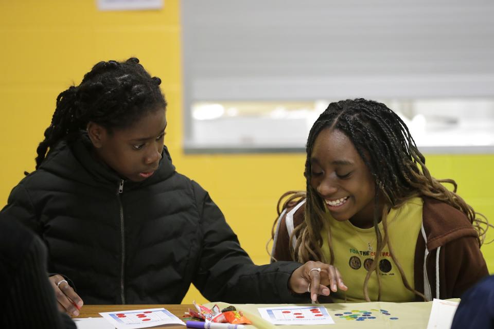 Tiwa Akinpelu, 11, left, and Princess Tomori, 12, have fun playing Black history bingo during a Black History Month event Feb. 27 at Franklin Elementary School in Appleton.