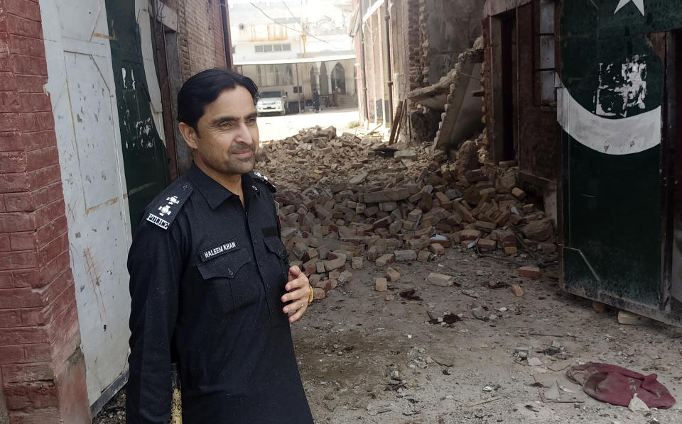 A security member stands guard inside a damages police compound after a suicide bomber attack, in the Bara Khyber Pakhtunkhwa, of Pakistan, Thursday, July 20, 2023. Suicide bombers attacked a sprawling compound housing a police station and government offices in northwest Pakistan on Thursday, killing at least two police officers and wounding over a dozen other people, police and rescue officials said. (AP Photo/Qazi Rauf)