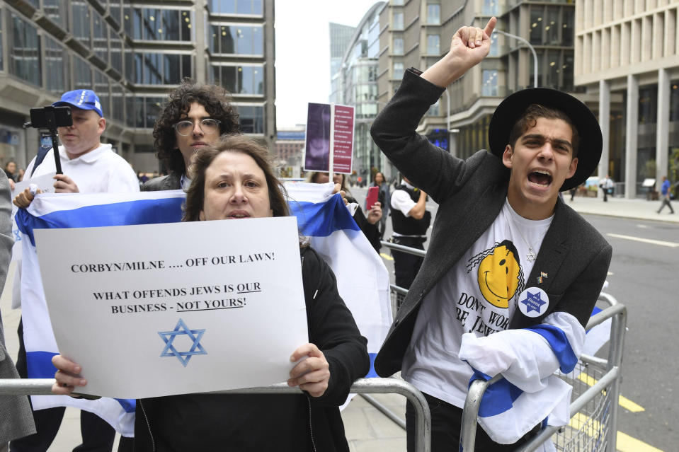 Activists react outside a meeting of the Labour National Executive Committee in London Tuesday Sept. 4, 2018 which is expected to decide on whether to adopt the International Holocaust Remembrance Alliance (IHRA) definition of anti-Semitism and its examples, which has been the subject of a bitter row within the party over recent months. (Stefan Rousseau/PA via AP)