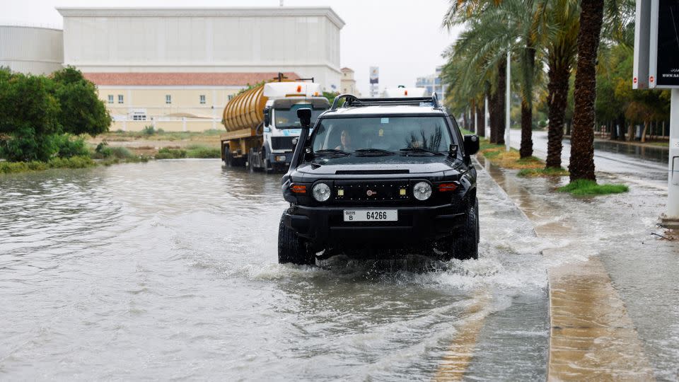 A car drives through a flooded road following a rainstorm in Dubai on May 2, 2024. - Rula Rouhana/Reuters