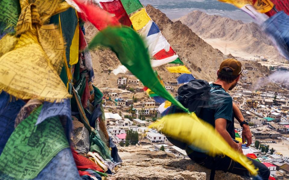 Hiker resting on the Peak of Victory near Namgyal Tsemo gompa (monastery) in Leh, Ladakh, India - Getty Images/iStock