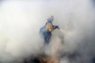 <p>A firefighters is covered in smoke as he battles a wildfire Friday, Nov. 9, 2018, in Agoura Hills, Calif.<br>(Photo from Marcio Jose Sanchez, AP) </p>