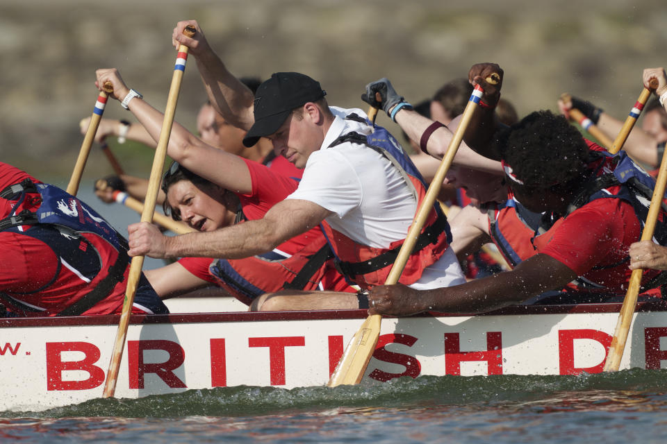 Britain's Prince William, center, participates in a dragon boat event in Singapore, Monday, Nov. 6, 2023. (AP Photo/Vincent Thian)