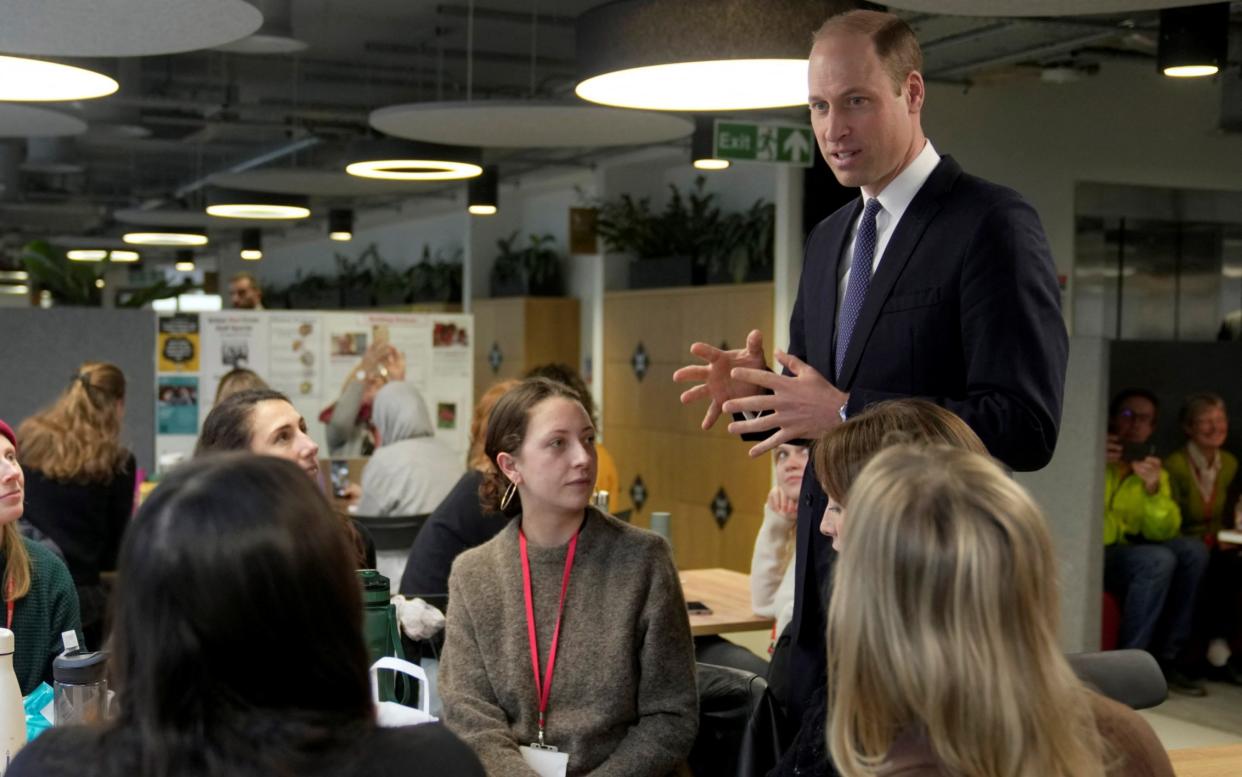 The Prince of Wales talks to British Red Cross employees in London on Tuesday, soon after his statement was released