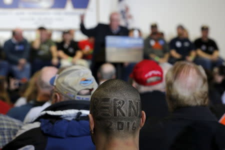 Supporters of U.S. Democratic presidential candidate and U.S. Senator Bernie Sanders listen as Sanders speaks during a campaign event at the United Steelworkers Local in Des Moines, Iowa January 26, 2016. REUTERS/Carlos Barria