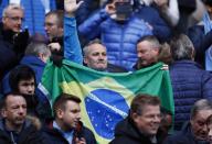 Britain Football Soccer - Manchester City v Chelsea - Premier League - Etihad Stadium - 3/12/16 Fan with a brazilian flag as a mark of respect for the victims of the Colombia plane crash containing the Chapecoense players and staff Action Images via Reuters / Jason Cairnduff Livepic EDITORIAL USE ONLY. No use with unauthorized audio, video, data, fixture lists, club/league logos or "live" services. Online in-match use limited to 45 images, no video emulation. No use in betting, games or single club/league/player publications. Please contact your account representative for further details.