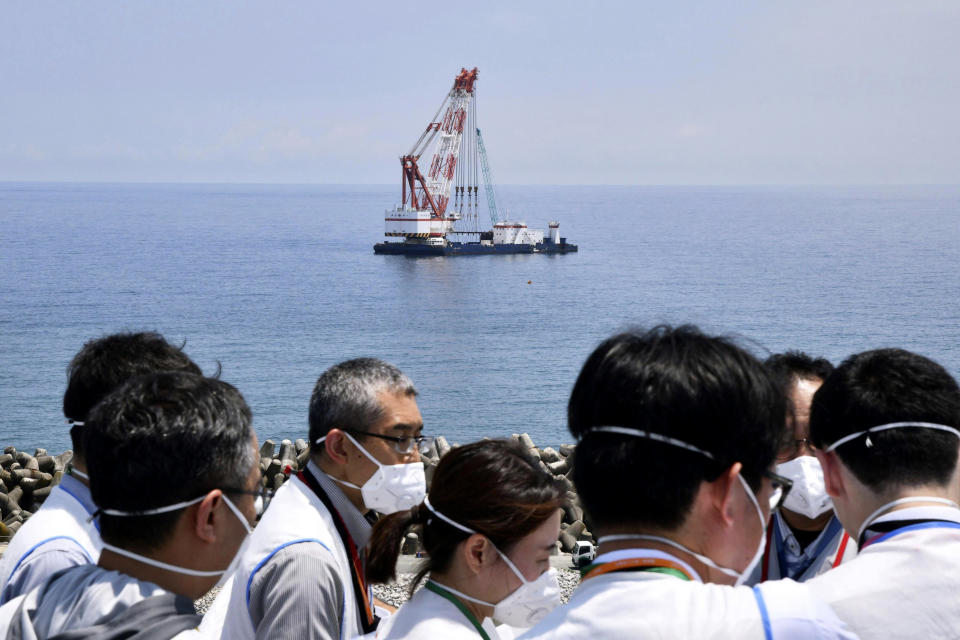 A work ship is seen off shore where Tokyo Electric Power Company Holdings said it installed the last piece of an undersea tunnel dug to be used to release the water offshore, during a media tour to the Fukushima Daiichi nuclear power plant in Fukushima, northern Japan Monday, June 26, 2023. All equipment needed for the release into the sea of treated radioactive wastewater from the wrecked Fukushima nuclear plant has been completed and will be ready for a safety inspection by Japanese regulators this week, the plant operator said Monday, as opposition to the plan continues in and outside Japan over safety concerns. (Kyodo News via AP)