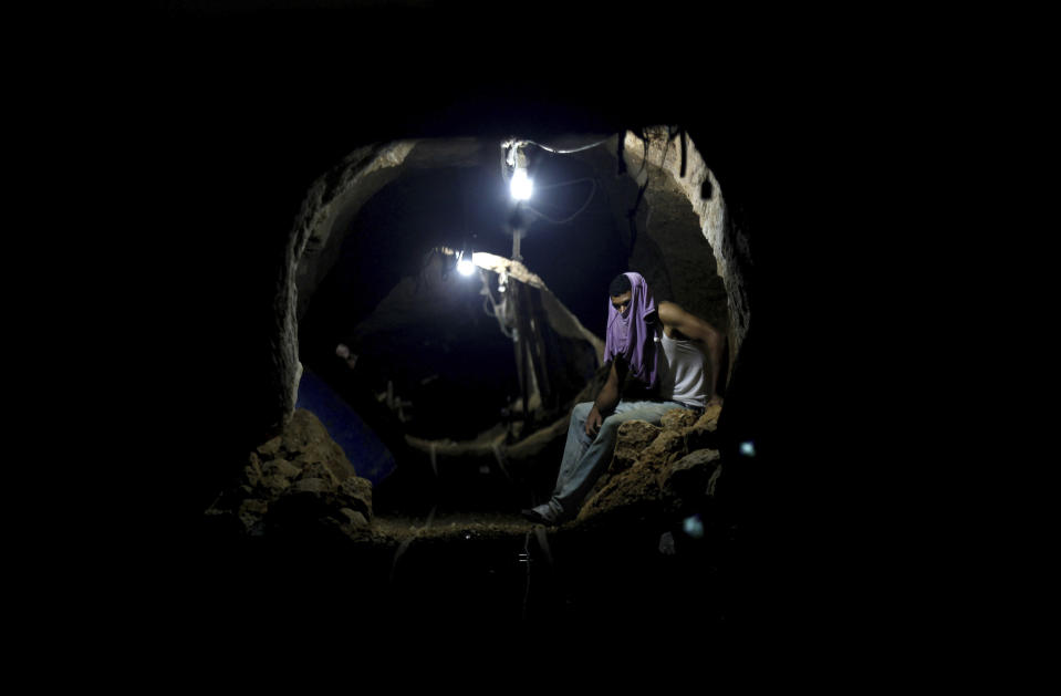 FILE - A Palestinian worker rests inside a smuggling tunnel in Rafah, on the border between Egypt and the southern Gaza Strip Sept. 30, 2013. An extensive labyrinth of tunnels built by Hamas stretches across the dense neighborhoods of the Gaza Strip, hiding militants, their missile arsenal and the over 200 hostages they now hold after an unprecedented Oct. 7, 2023, attack on Israel. (AP Photo/Hatem Moussa, File)