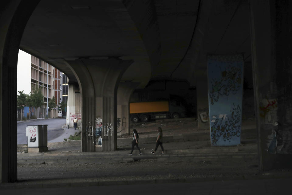 Anti-government protesters walk under a bridge as they leave a protest in Beirut, Lebanon, Saturday, June 13, 2020. Lebanese protesters took to the streets in Beirut and other cities in mostly peaceful gatherings against the government, calling for its resignation as the small country sinks deeper into economic distress. (AP Photo/Hassan Ammar)