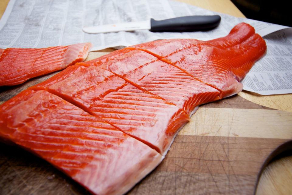 wild caught salmon raw fillet on cutting board