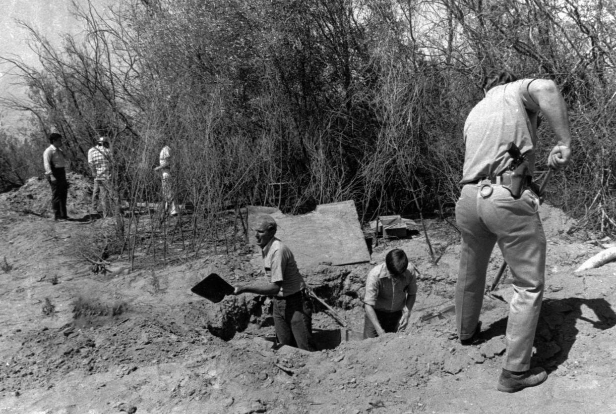 FILE - In this July 17, 1976, photo members of the Alameda County Crime Lab and FBI are pictured working around the opening to the van where 26 Chowchilla school children and their bus driver were held captive at a rock quarry near Livermore, Calif. California parole commissioners have recommended parole for the last of three men convicted of hijacking a school bus full of children for $5 million ransom in 1976. The two commissioners acted Friday, March 25, 2022, in the case of 70-year-old Frederick Woods. (AP Photo, File)