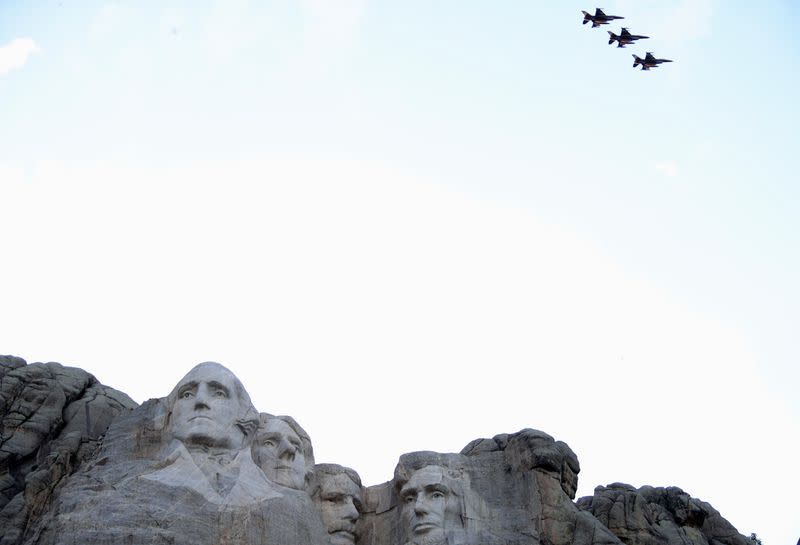 An aerial flypast takes place over Mt. Rushmore during South Dakota's U.S. Independence Day Mount Rushmore fireworks celebrations in Keystone, South Dakota