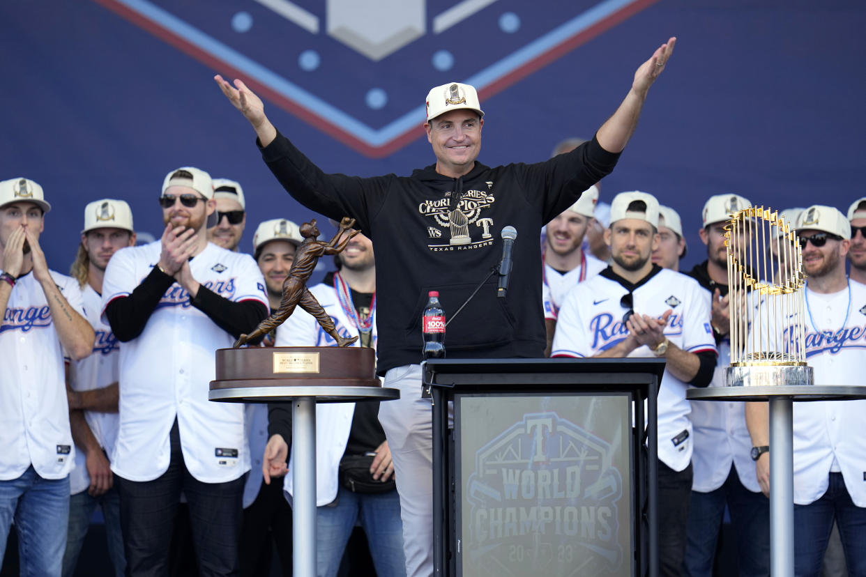 FILE - Texas Rangers general manager Chris Young, center, addresses fans during a World Series baseball championship celebration Nov. 3, 2023, in Arlington, Texas. (AP Photo/Julio Cortez, File)