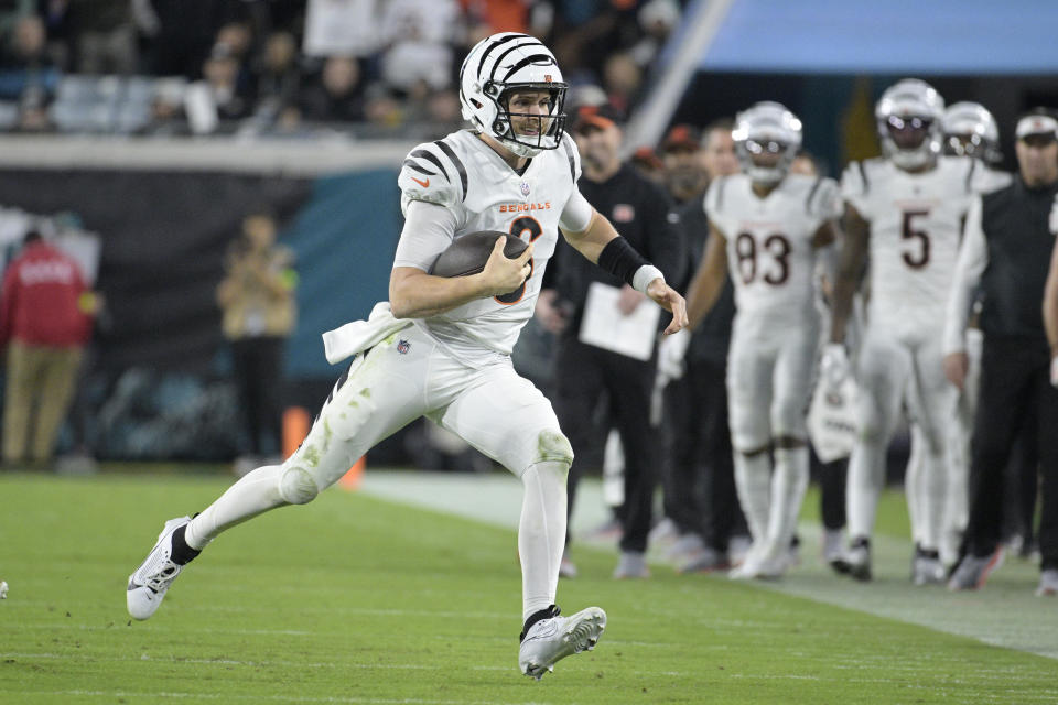 Cincinnati Bengals quarterback Jake Browning (6) runs with the football during the second half of an NFL football game against the Jacksonville Jaguars, Monday, Dec. 4, 2023, in Jacksonville, Fla. (AP Photo/Phelan M. Ebenhack)