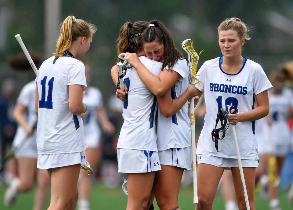 Bronxville's Campbell Molloy, right, hugs Anna Becker after their loss to Skaneateles in the NYSPHSAA Girls Lacrosse Championships Class D final in Cortland, N.Y., Saturday, June 10, 2023. Bronxville’s season ended with an 11-6 loss to Skaneateles.