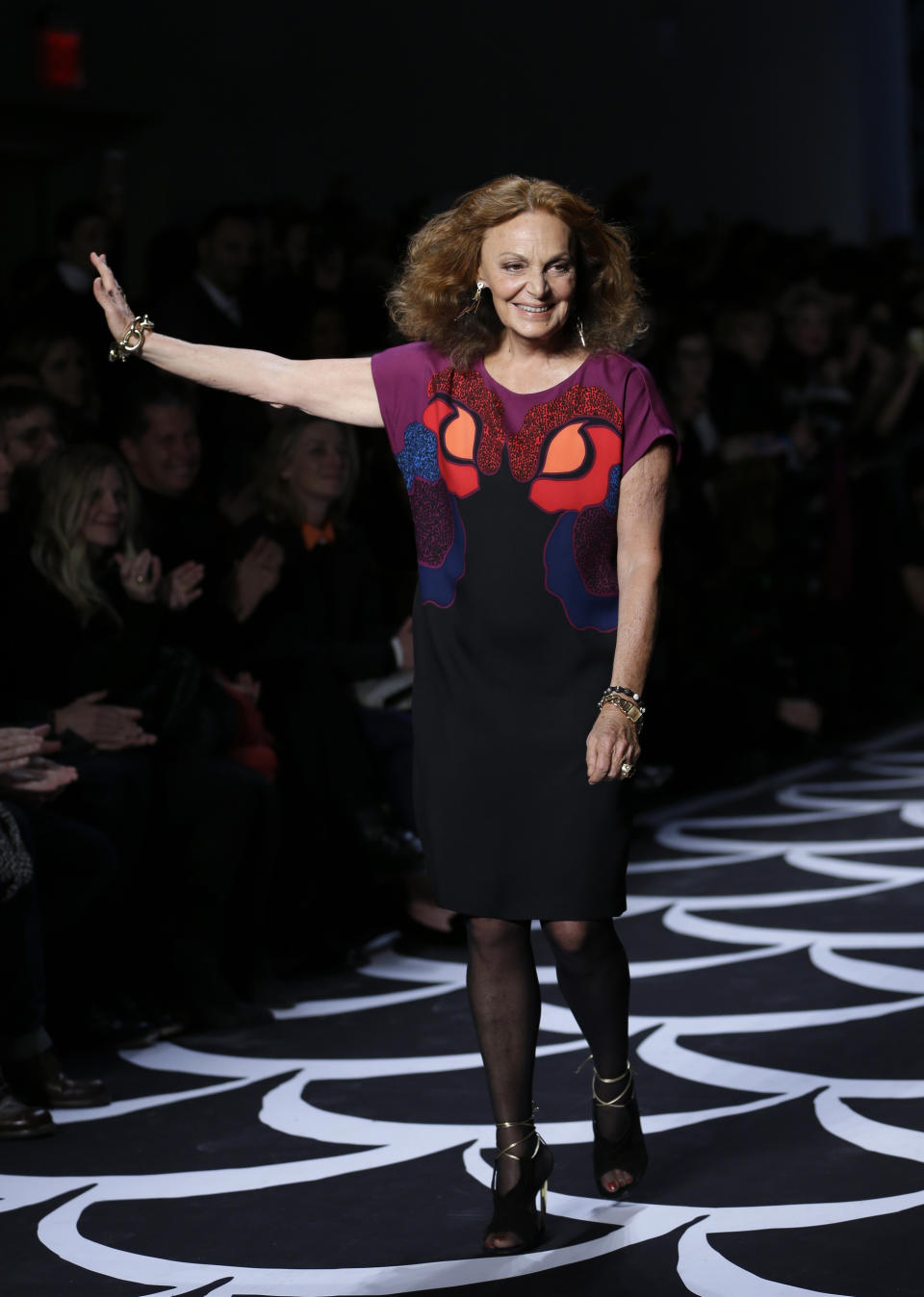 Designer Diane von Furstenberg greets the audience after her Fall 2014 collection is modeled during Fashion Week in New York, Sunday, Feb. 9, 2014. (AP Photo/Seth Wenig)