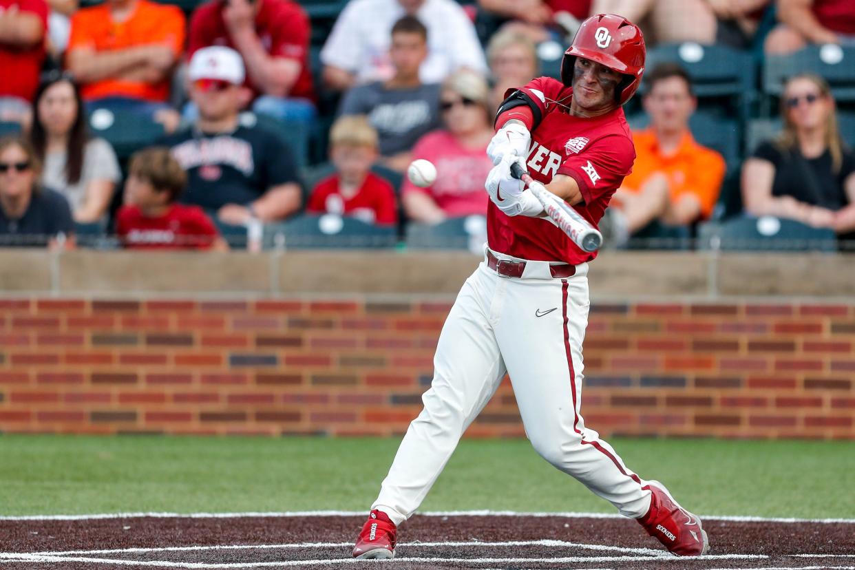 Oklahoma outfielder Bryce Madron (12) hits during the Bedlam baseball game between the Oklahoma Sooners and the Oklahoma State Cowboys at L. Dale Mitchell Park in Norman, Okla., on Saturday, May 20, 2023.
