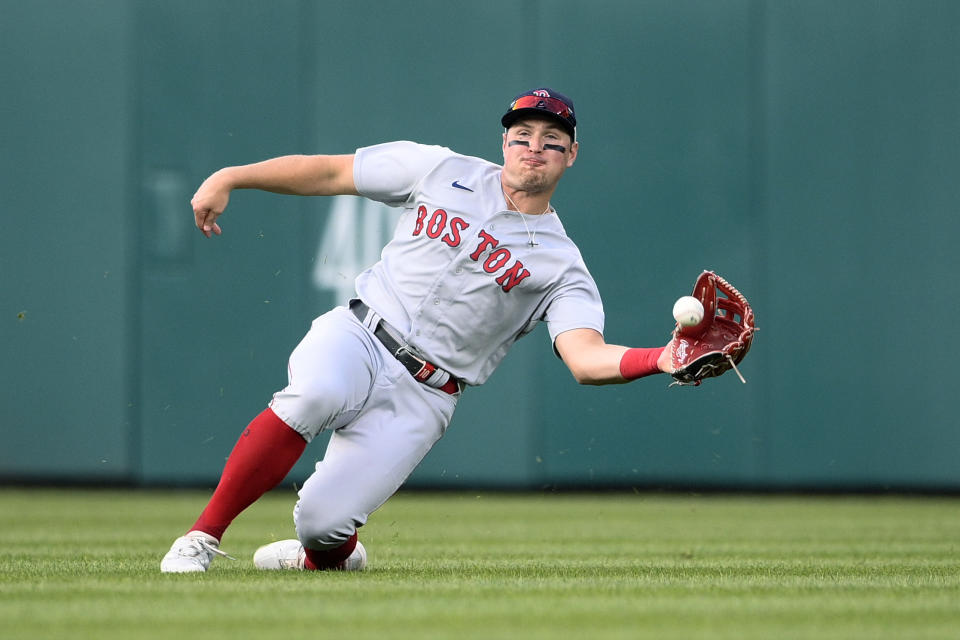 FILE - Boston Red Sox center fielder Hunter Renfroe makes a catch for an out on a fly ball hit by Washington Nationals' Alcides Escobar during the seventh inning of a baseball game Oct. 2, 2021, in Washington. The Red Sox reacquired outfielder Jackie Bradley Jr. from Milwaukee in a trade that sent Renfroe to the Brewers on Wednesday, Dec. 1. (AP Photo/Nick Wass, File)