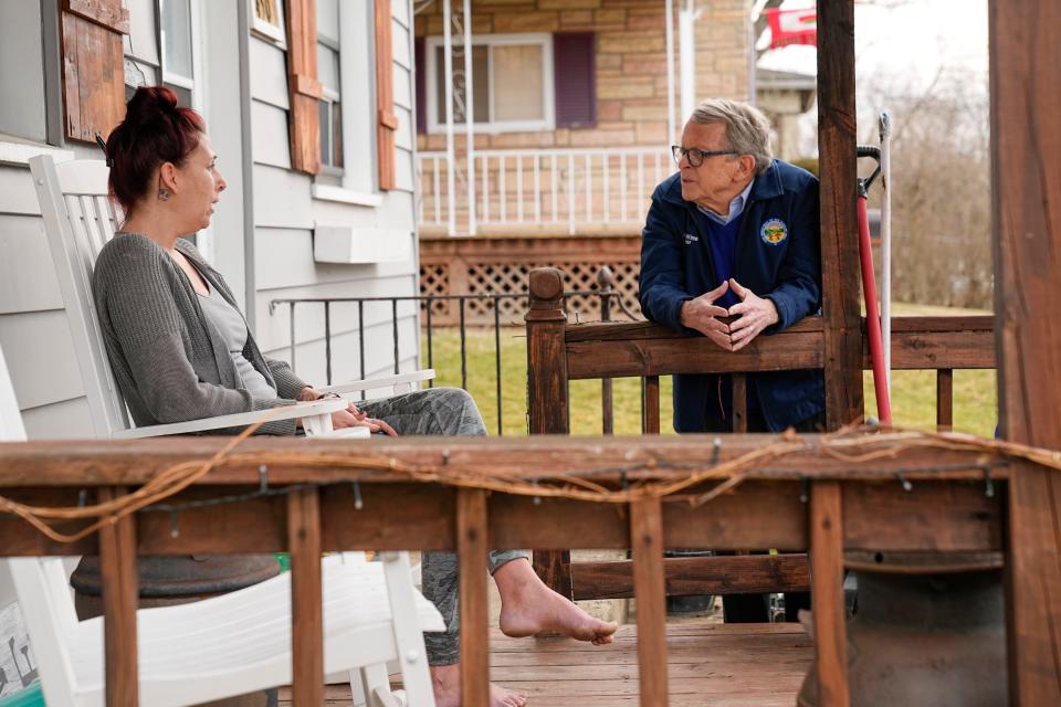 Gov. Mike DeWine stops to talk to East Palestine resident Rachel Jackson, who expressed concern for the safety of her kids and pets.