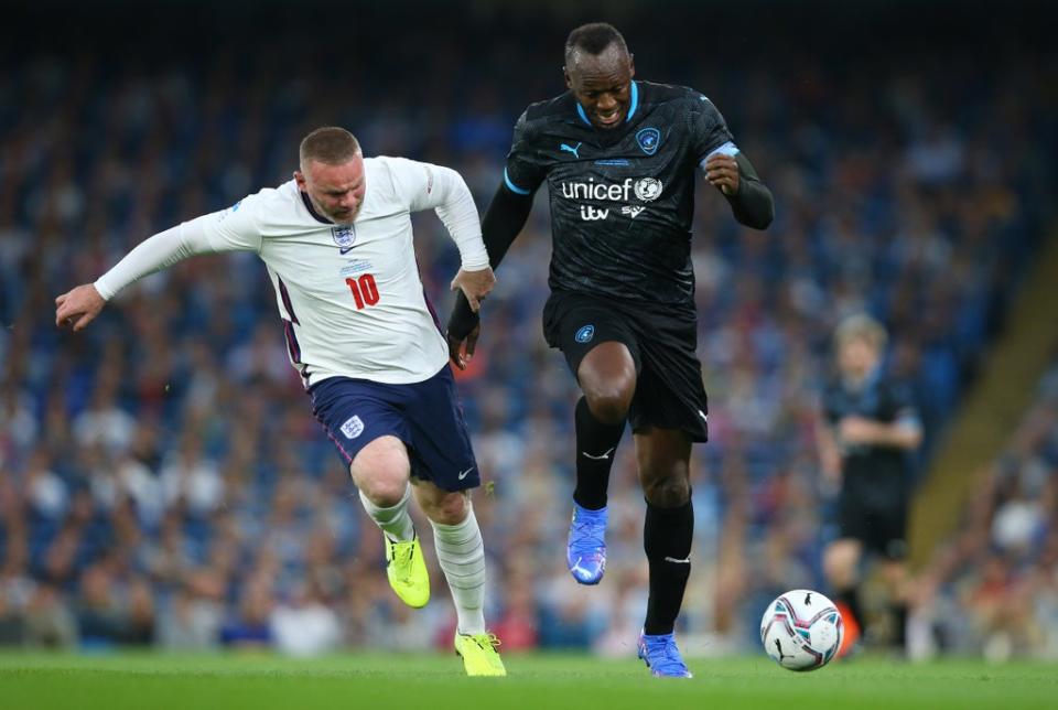 Usain Bolt holds off the challenge of Wayne Rooney during Soccer Aid (Getty Images)