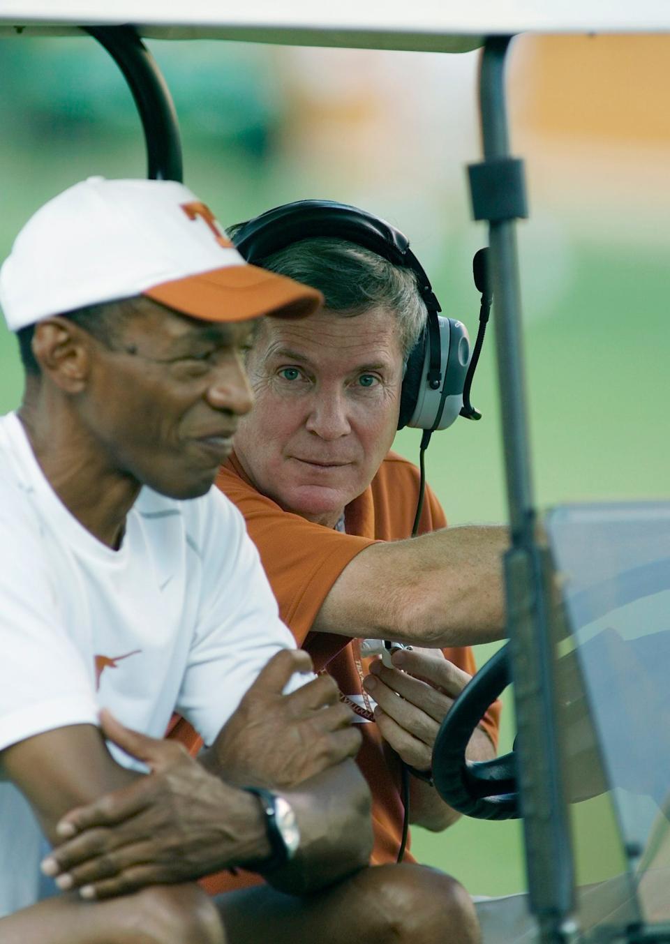 Texas head football coach Mack Brown, right, sits with Cleve Bryant, left, during a scrimmage held by the defending national champions Saturday, Aug. 19, 2006, in Austin, Texas. Bryant is Associate Athletics Director for Football Operations