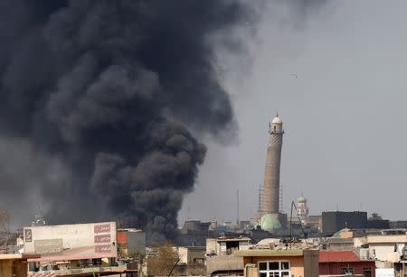 Smoke rises from clashes near Mosul's Al-Habda minaret at the Grand Mosque, March 17, 2017. Islamic State's black flag had been flying over its 150-foot (45-meter) leaning minaret since June 2014. REUTERS/Youssef Boudlal