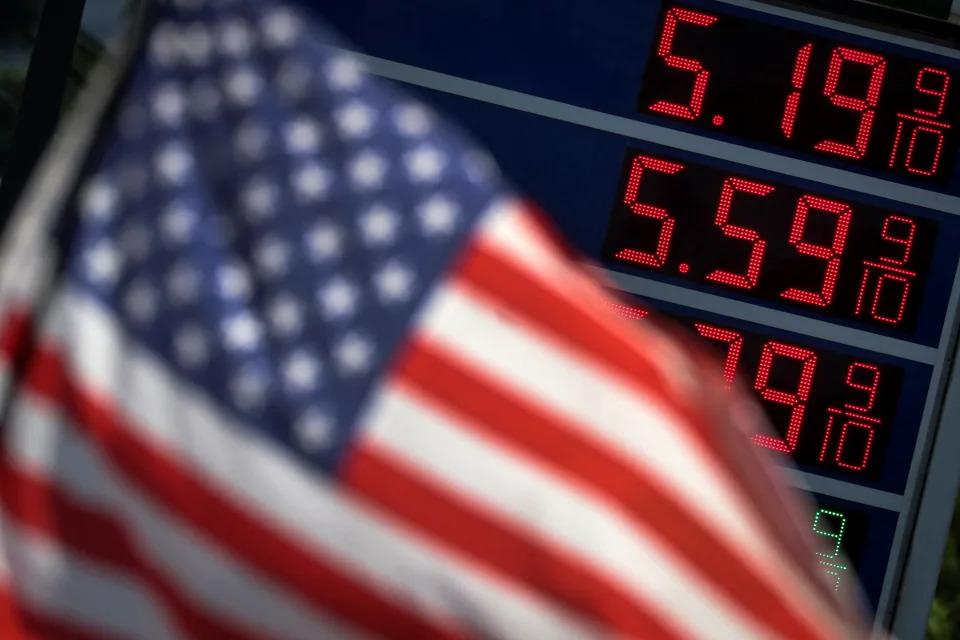 Gasoline prices are displayed at an Exxon gas station behind American flag in Edgewater, New Jersey, U.S., June 14, 2022. REUTERS/Mike Segar