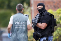 <p>Members of French special police forces of Research and Intervention Brigade (BRI) and French scientific police are seen at the scene during a raid after a hostage-taking in the church in Saint-Etienne-du-Rouvray near Rouen in Normandy, France, July 26, 2016. (REUTERS/Pascal Rossignol)</p>