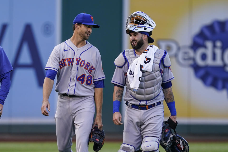 New York Mets starting pitcher Jacob deGrom, left and catcher Tomas Nido walk to the dugout before a baseball game against the Washington Nationals at Nationals Park, Tuesday, Aug. 2, 2022, in Washington. (AP Photo/Alex Brandon)