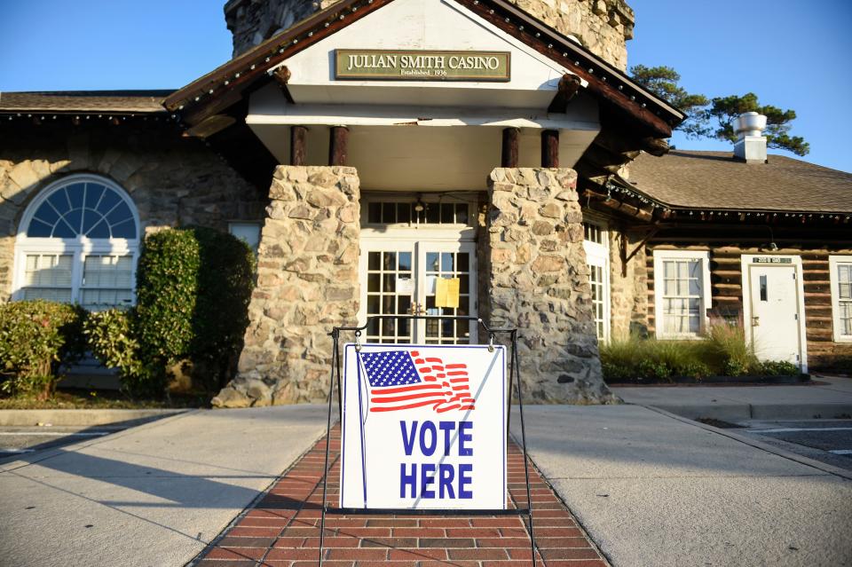 A "vote here" sign sits outside Julian Smith Casino as the sun rises on Tuesday, Nov. 8, 2022.