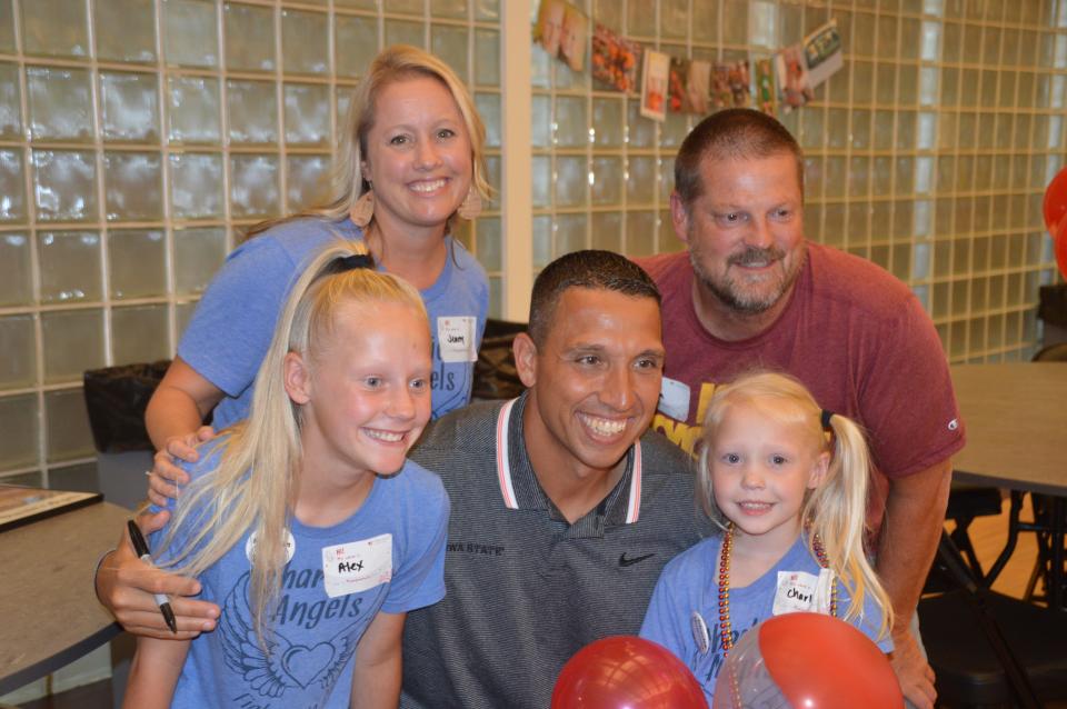 Jenny and Tim Hugunin and their daughters Alex, left, and Charlie pose with Iowa State's head football coach Matt Campbell during a cystic fibrosis fundraiser in 2019.