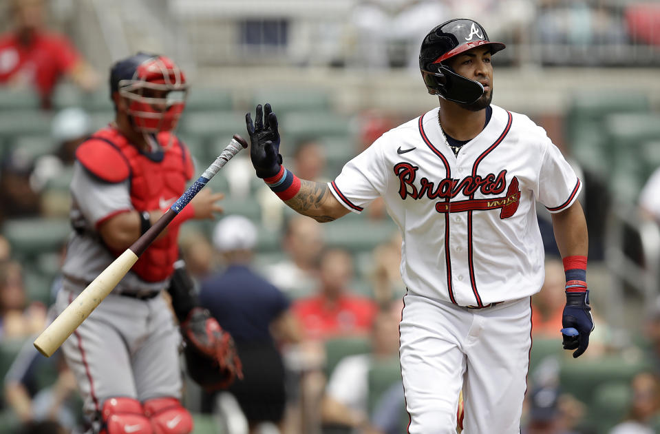 Atlanta Braves' Eddie Rosario flips his bat after hitting an RBI sacrifice fly off Washington Nationals' Paolo Espino in the third inning of a baseball game, Sunday, July 10, 2022, in Atlanta. (AP Photo/Ben Margot)