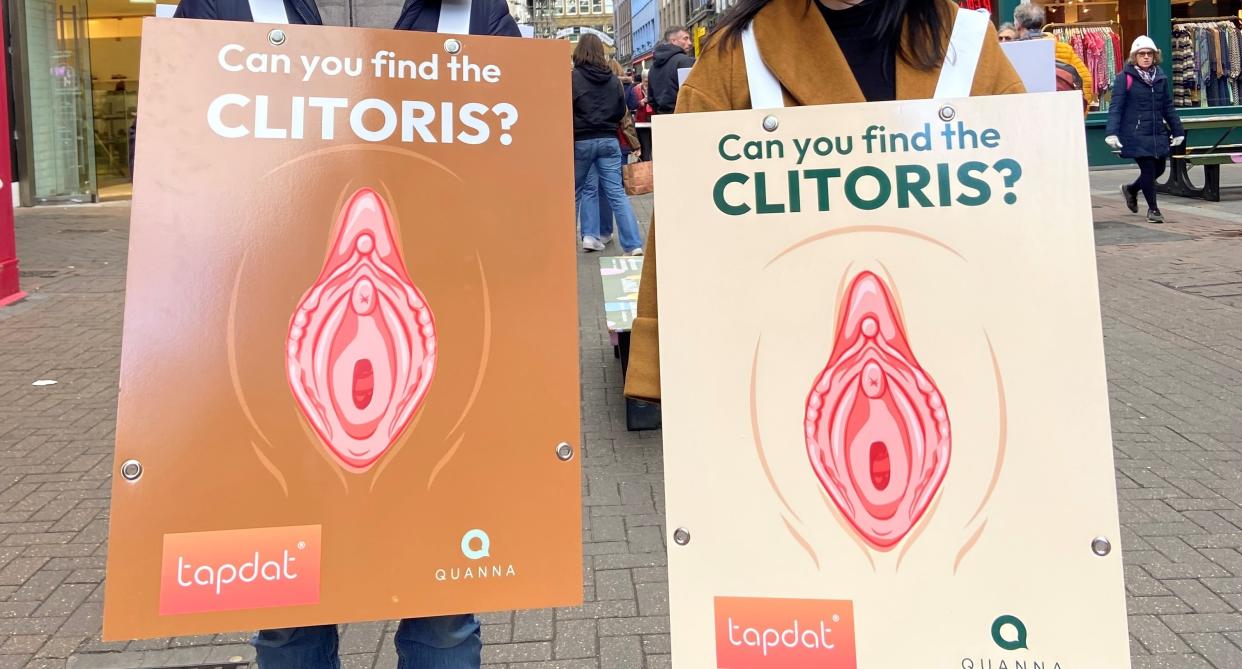 An image of two people wearing billboards showing the clitoris. (TapDat/Quanna)