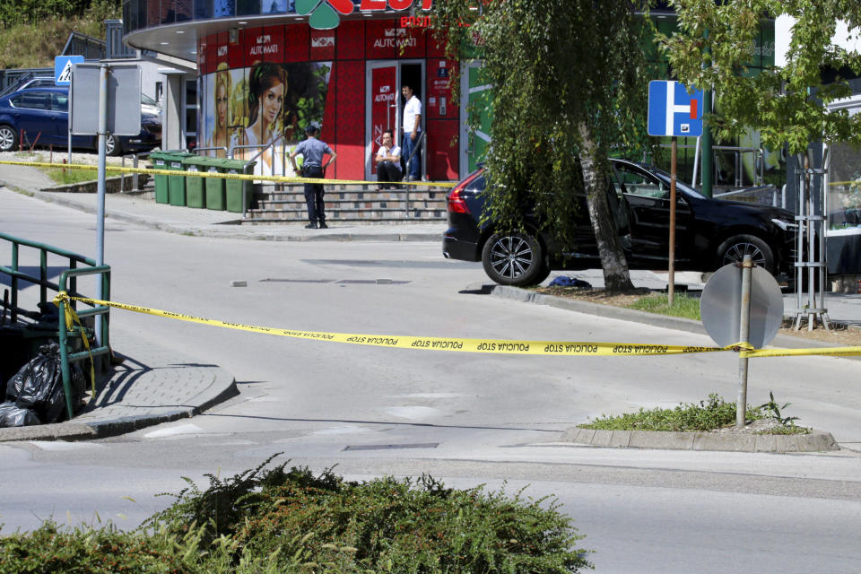 Car is seen on the site of a shooting, in the small Bosnian town of Gradacac, Bosnia, Friday, Aug. 11, 2023. Police in Bosnia launched on Friday a major chase for a man who claimed to have shot and killed his wife while broadcasting it live on Instagram. (AP Photo)