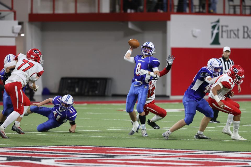 Warner QB Hunter Cramer (8) attempts a pass with Gregory defender Eli Fogel (12) bearing down on him during the SDHSAA 9A State Championship game Thursday November 10th, 2022 in Vermillion, SD.  Gregory won 36-23.