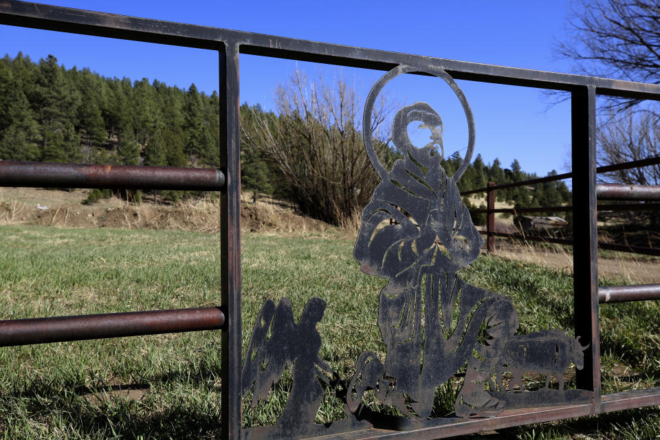 An image of San Isidro, patron saint of farmers, is sculpted in the metal gate outside the chapel dedicated to the Catholic saint near the hamlet of Holman, New Mexico, Saturday, April 15, 2023. The chapel or "morada" is used for prayer, study and hosting pilgrims by a local Catholic brotherhood that has long played a crucial role in preserving the faith in these remote mountain valleys. (AP Photo/Giovanna Dell'Orto)