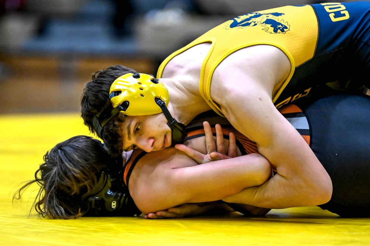Grand Ledge's Eben Abdo, top, wrestles with Jackson's Cameron Weeder in the 120-pound match during the Division 1 district final on Wednesday, Feb. 7, 2024, at Holt Jr. High School. Abdo won the match.