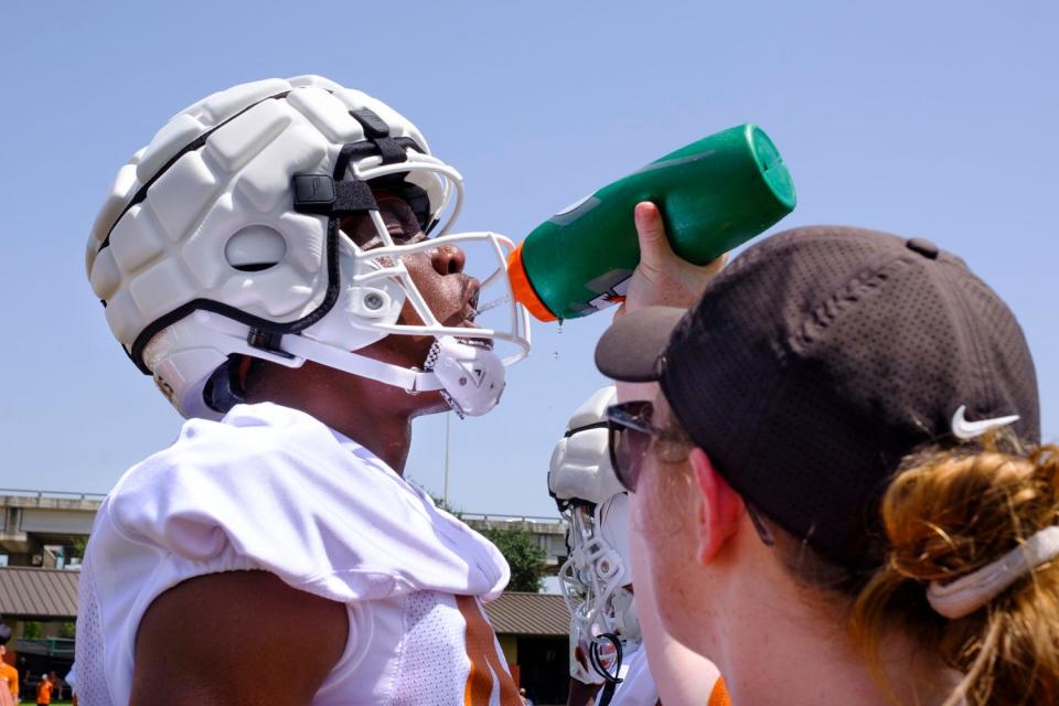 Texas defensive back Ziky Umeozulu gets some water in between drills during the first summer practice for the Longhorns at Denius Fields on Wednesday. Texas enters its first season in the SEC with high expectations after going 12-2 and reaching the College Football Playoff a year ago.