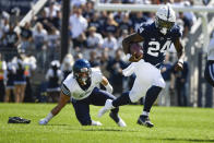 Penn State running back Keyvone Lee (24) runs out of his shoe as Villanova defensive back Ethan Potter (34) looks on during the second quarter of an NCAA college football game in State College, Pa., on Saturday, Sept.25, 2021. (AP Photo/Barry Reeger)