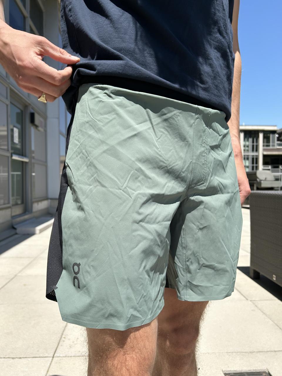 man wearing ON Lightweight Shorts in green