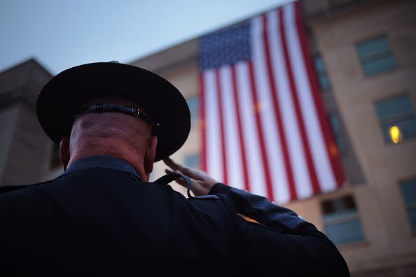 ARLINGTON, VIRGINIA - SEPTEMBER 11: A first responders watches as an American flag is unfurled during a ceremony observing the 9/11 terrorist attacks at the Pentagon on September 11, 2023 in Arlington, Virginia. The Defense Department held a remembrance ceremony for the 184 lives lost in the 2001 terrorist attack on the Pentagon. Today marks the 22nd anniversary of September 11, 2001 terrorist attacks at the World Trade Center, the Pentagon and Shanksville, Pennsylvania. (Photo by Win McNamee/Getty Images)