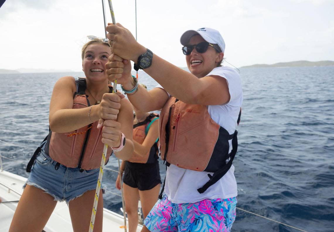 Two advanced sailing students help raise the main sail on the way to Virgin Gorda on Monday, Aug. 1, 2022, in the British Virgin Islands.