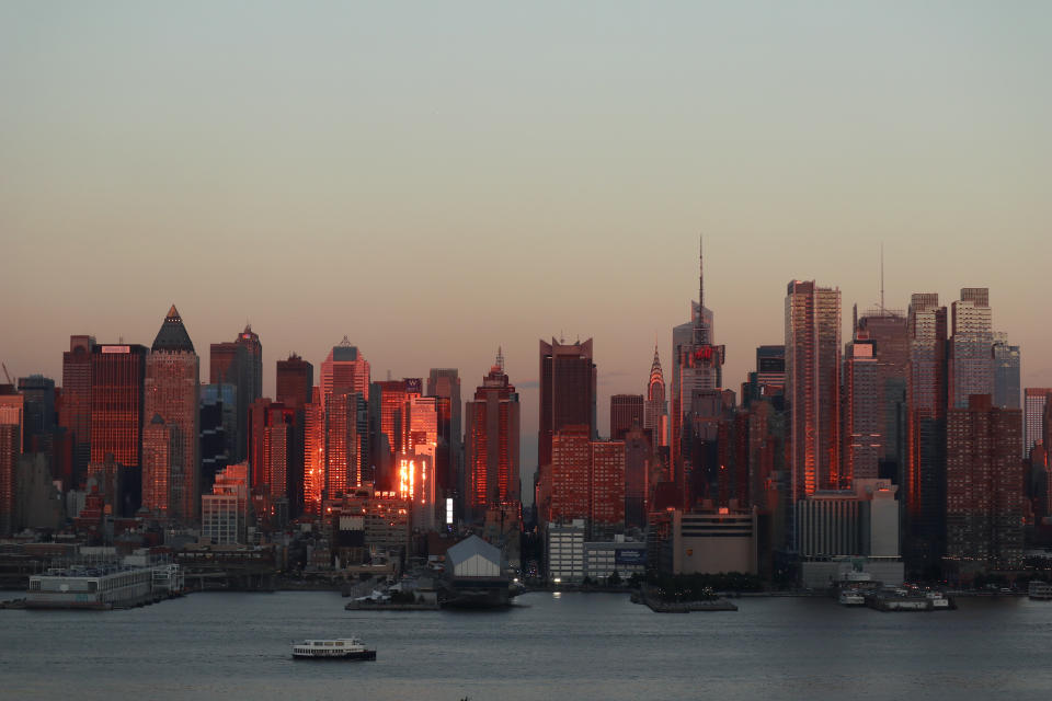 The sun sets on midtown Manhattan and the Chrysler Building on the summer solstice in New York City on June 21, 2017 as seen from Weehawken, NJ.