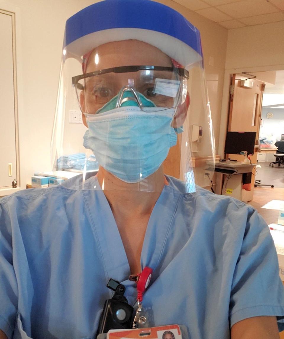 Nurse Celia Nieto, 44, poses for a photo while wearing two masks, safety glasses and a face shield, while on duty at the Las Vegas-area hospital she works at caring for COVID-19 patients.