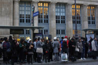 Commuters wait for a bus in front of the Gare du Nord railway station, in Paris, Thursday, Dec. 12, 2019. France's prime minister said Wednesday the full retirement age will be increased for the country's youngest, but offered a series of concessions in an ill-fated effort to calm a nationwide protest against pension reforms that critics call an erosion of the country's way of life. (AP Photo/Thibault Camus)