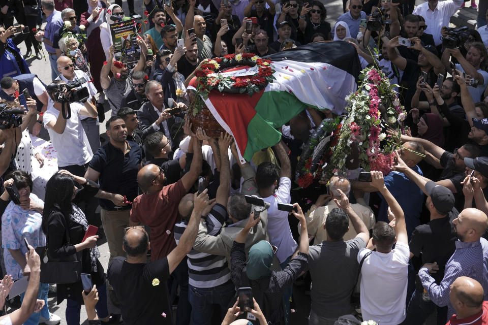 Family, friends and colleagues of slain Al Jazeera journalist Shireen Abu Akleh carry her coffin to a hospital in the east Jerusalem neighbourhood of Sheikh Jarrah, Thursday, May 12, 2022. Abu Akleh, a Palestinian-American reporter who covered the Mideast conflict for more than 25 years, was shot dead Wednesday during an Israeli military raid in the West Bank town of Jenin. (AP Photo/Mahmoud Illean)