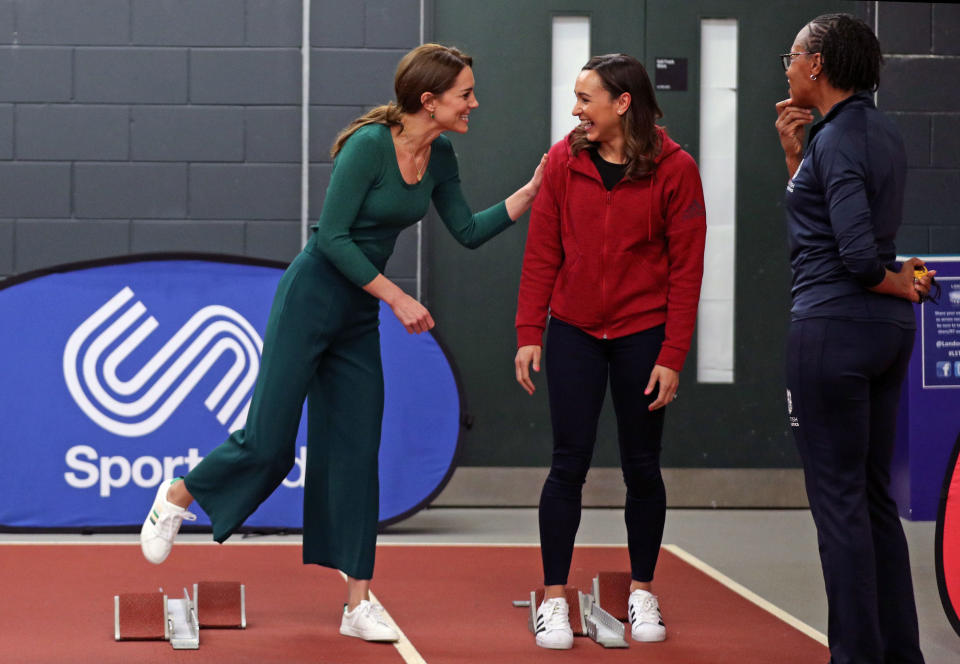 Kate wears wide legged trousers from Zara and M&S's Ribbon Detail Lace Up Trainers while chatting to heptathlete Jessica Ennis-Hill during a SportsAid Stars event at the London Stadium in Stratford on 26 February 2020. (Yui Mok - WPA Pool/Getty Images)