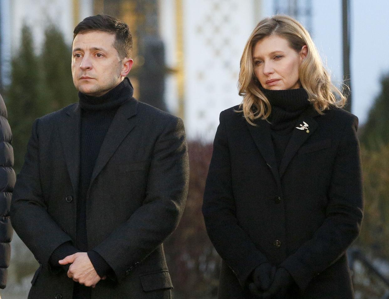 FILE - Ukraine President Volodymyr Zelenskyy and his wife Olena pay tribute at a monument to victims of the Great Famine in Kyiv, Ukraine, Saturday, Nov. 23, 2019. 