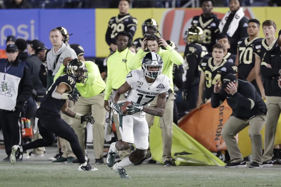 Michigan State wide receiver Tre Mosley (17) runs away from Wake Forest defensive back Amari Henderson (4) during the second half of the Pinstripe Bowl NCAA college football game Friday, Dec. 27, 2019, in New York. (AP Photo/Frank Franklin II)
