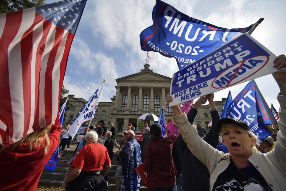 President Donald Trump supporters cheer during a rally, Saturday, Nov. 7, 2020, in Atlanta. (AP Photo/Mike Stewart)
